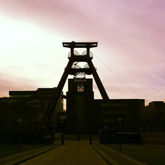 Silhouette of a coal mining tower at sunset