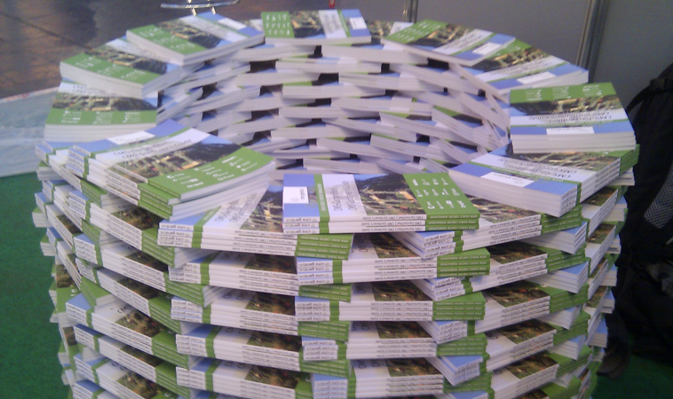 Small stacks of books laid out like bricks in a cylindric form